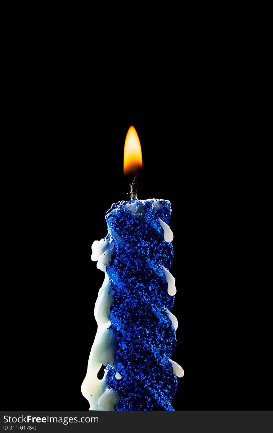 Close-up blue candle isolated on black