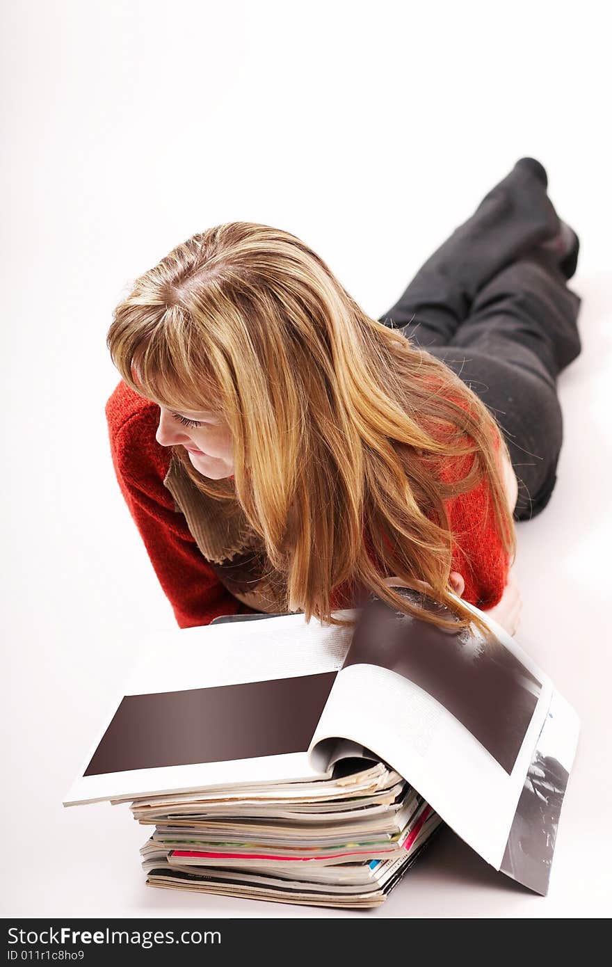 An image of a girl reading magazines. An image of a girl reading magazines