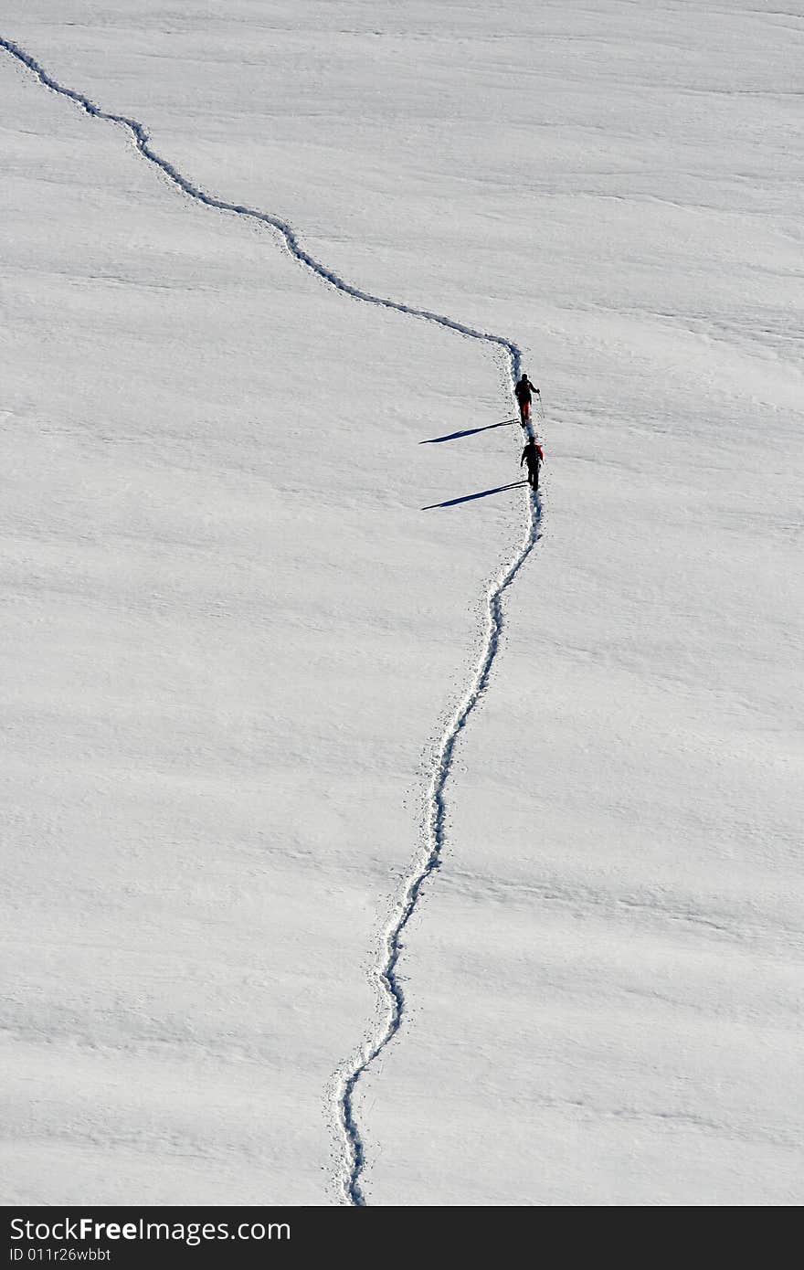 People who are crossing a glacier