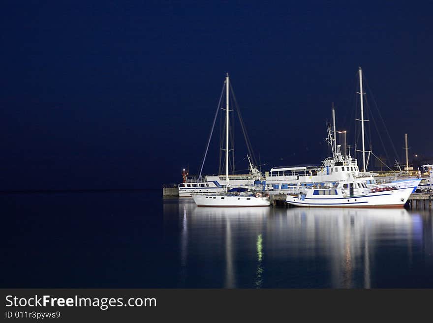 Ships near the pier. Shot at night. Ships near the pier. Shot at night.