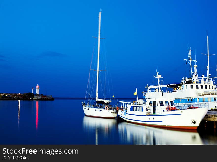 Boats near the pier. Shot at night.