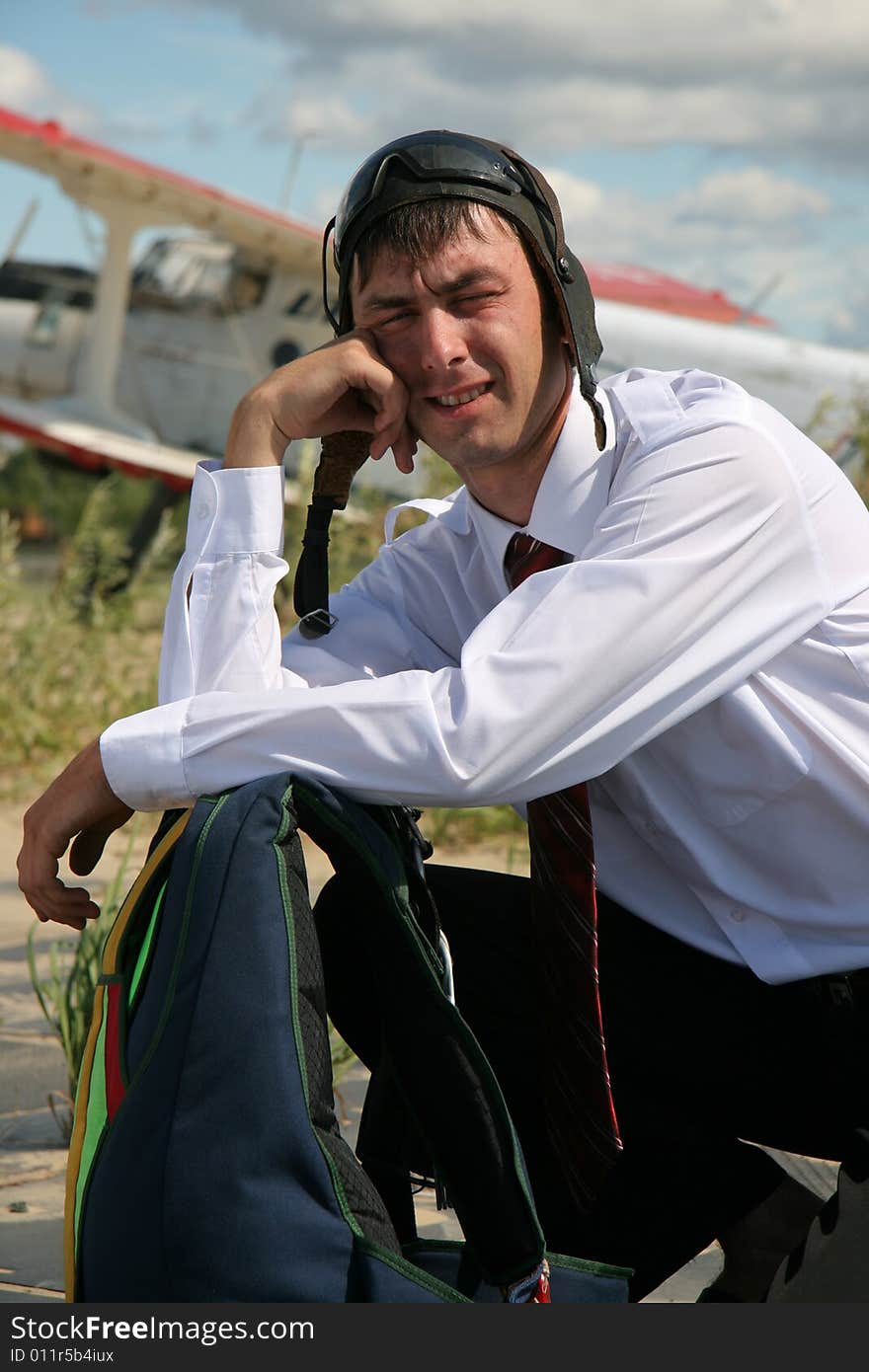 The Young man with parachute on background of the airplane-biplane. The Young man with parachute on background of the airplane-biplane.