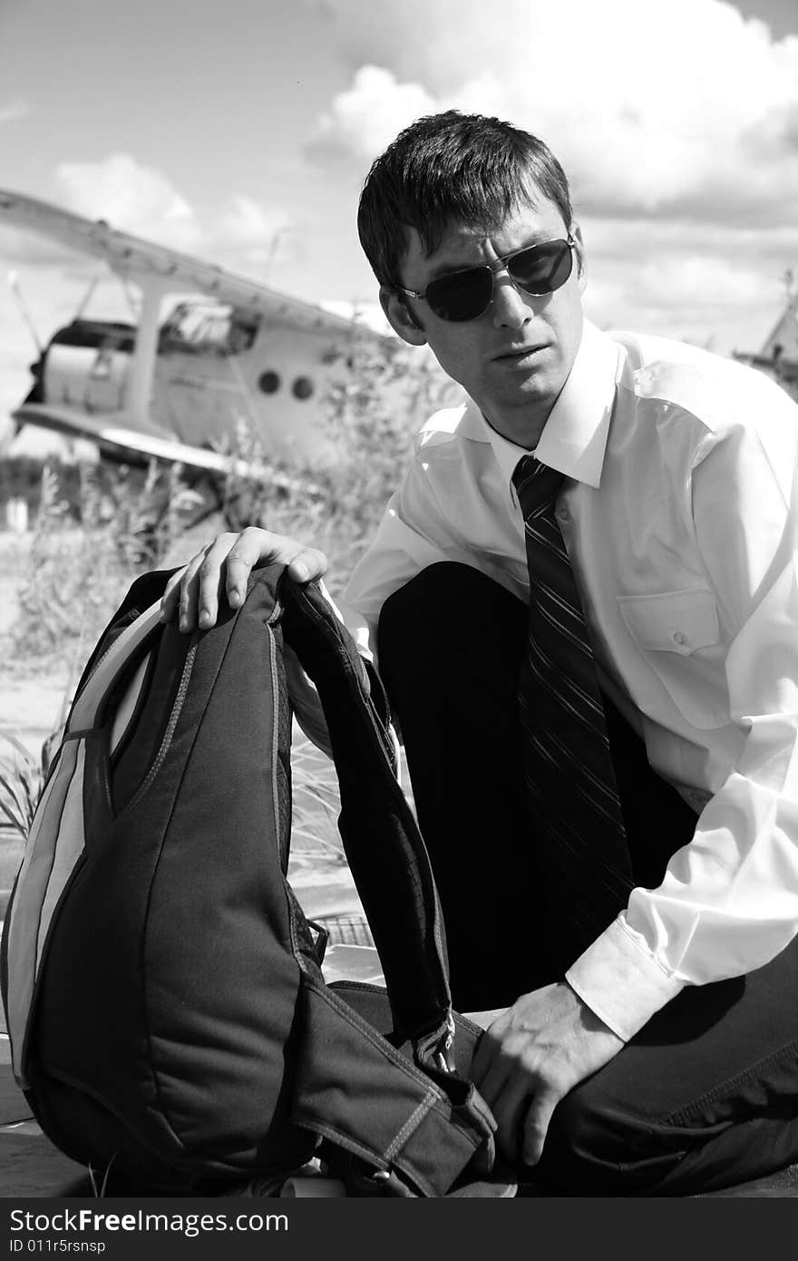 The Young man with parachute on background of the airplane-biplane. The Young man with parachute on background of the airplane-biplane.