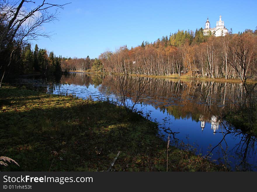 Cathedral on background yard, wood and blue sky. Cathedral on background yard, wood and blue sky