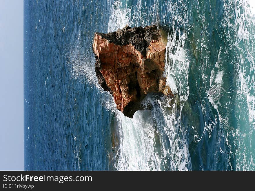 Stone in a sea, water-wave splash