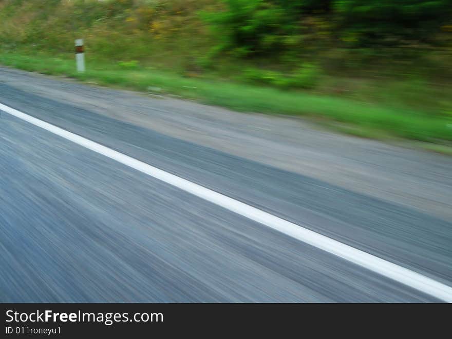 Side of the empty highway blurred due to fast motion