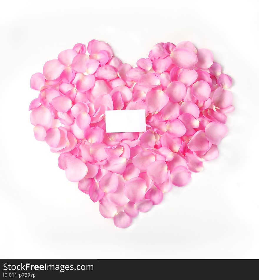 Pink rose petals forming a heart with blank card - isolated. Pink rose petals forming a heart with blank card - isolated