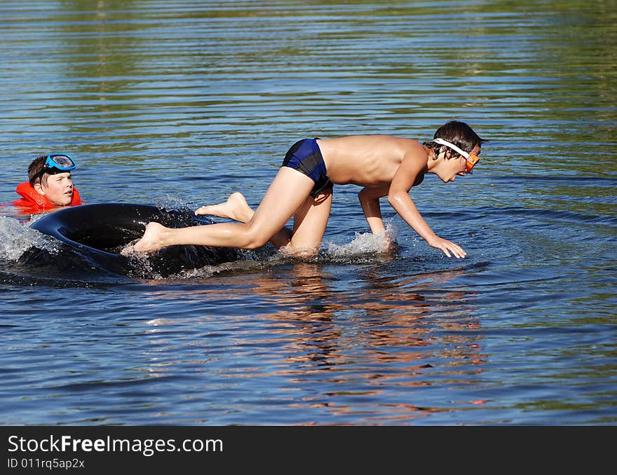 The boy is watching as his friend falling down off the tube. The boy is watching as his friend falling down off the tube.