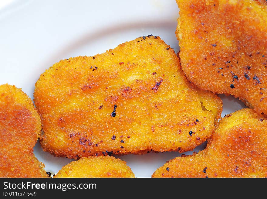 Hot and fresh chicken cutlets on the plate. Narrow depth of field. Hot and fresh chicken cutlets on the plate. Narrow depth of field.