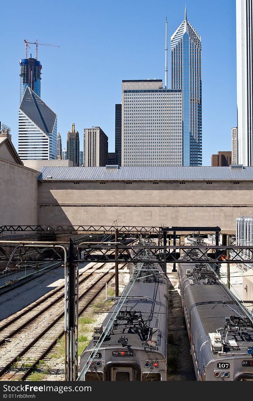 The railway runs into the heart of downtown Chicago. Trains in the foreground and city skyline in the background. The railway runs into the heart of downtown Chicago. Trains in the foreground and city skyline in the background.