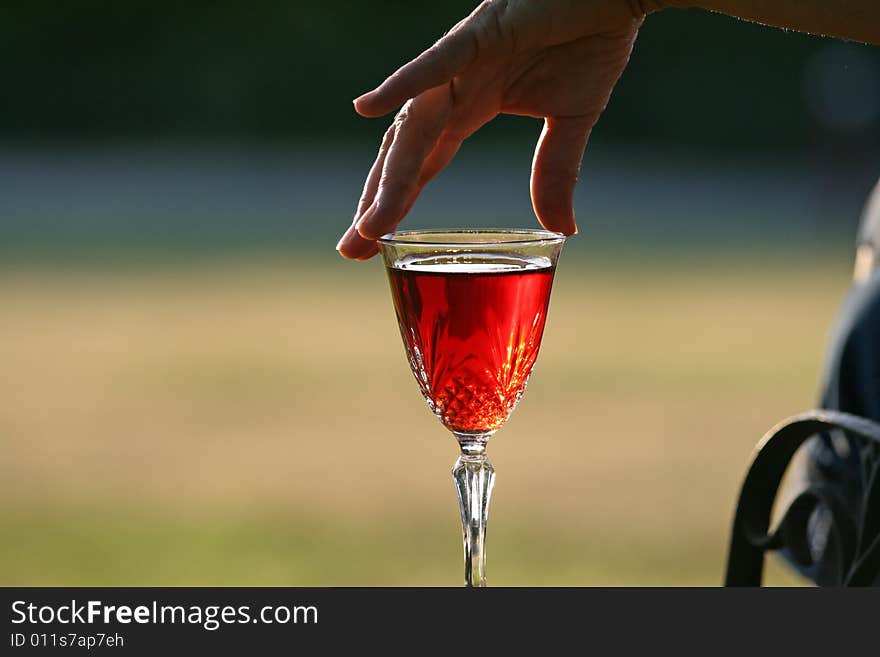 Woman Reaches For A Glass Of Chardonne