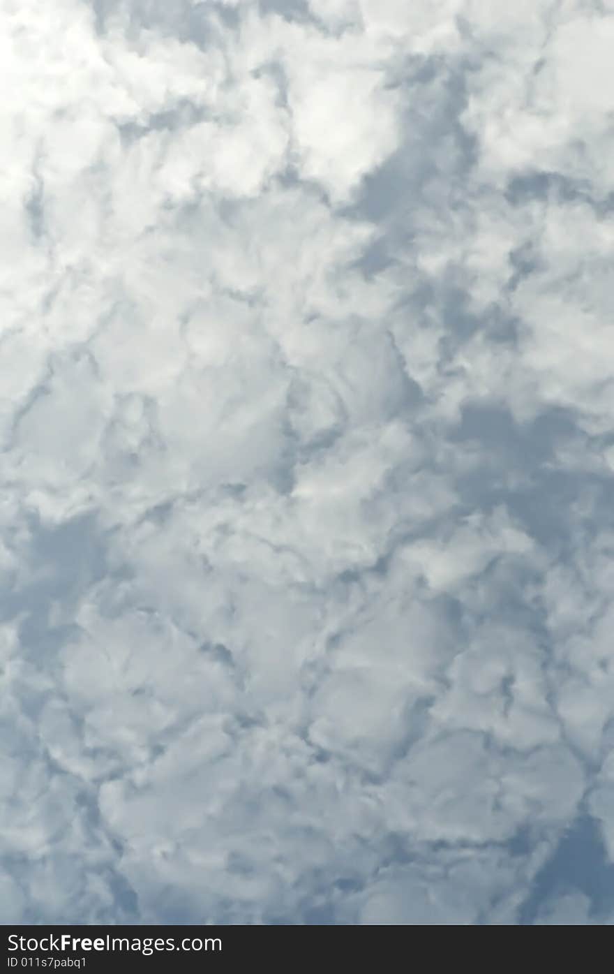 A dusty blue sky with clouds