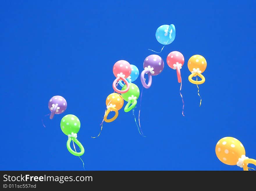 Colorful balloons flying in the blue sky.