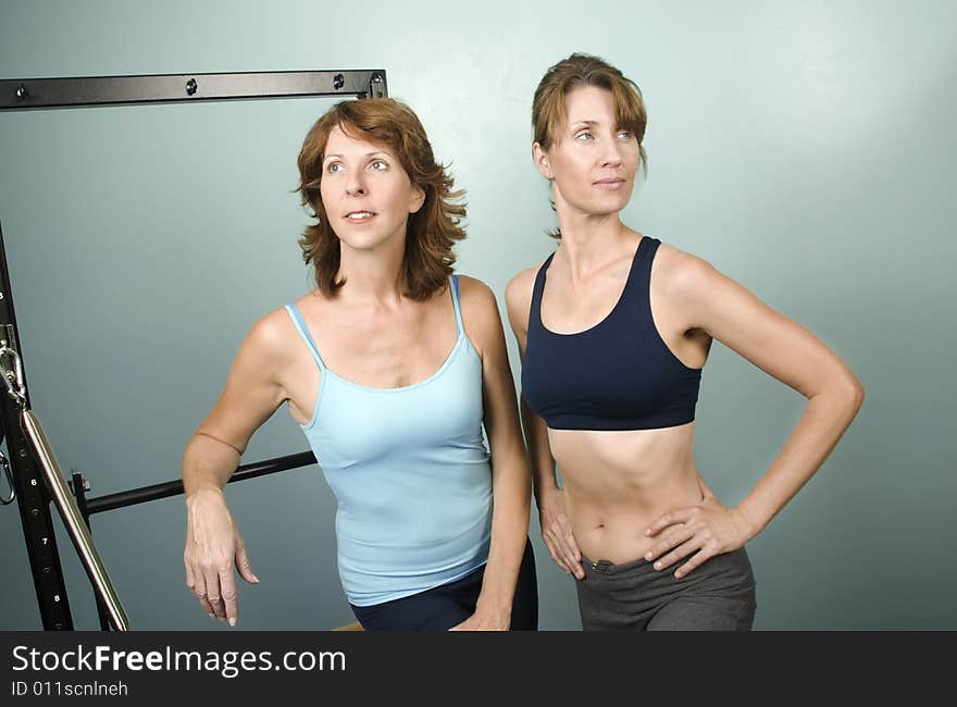 Portrait of Two Pretty Personal Trainers in a Gym. Portrait of Two Pretty Personal Trainers in a Gym