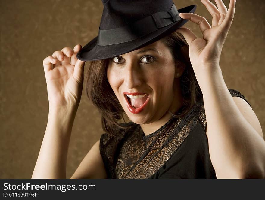 Pretty Hispanic Woman Tipping Her Fedora Hat. Pretty Hispanic Woman Tipping Her Fedora Hat