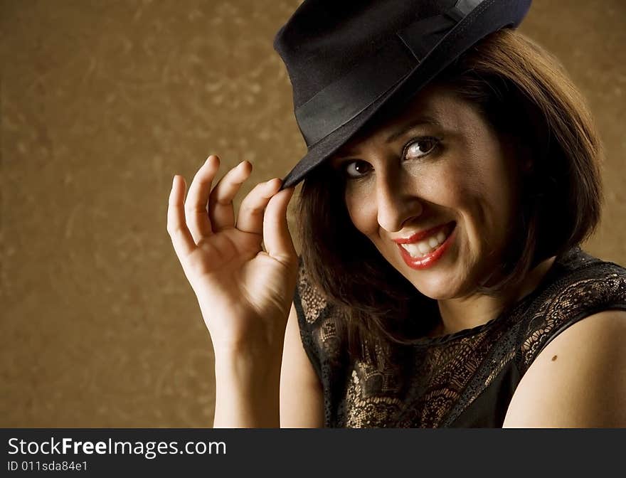 Pretty Hispanic Woman Tipping Her Fedora Hat. Pretty Hispanic Woman Tipping Her Fedora Hat