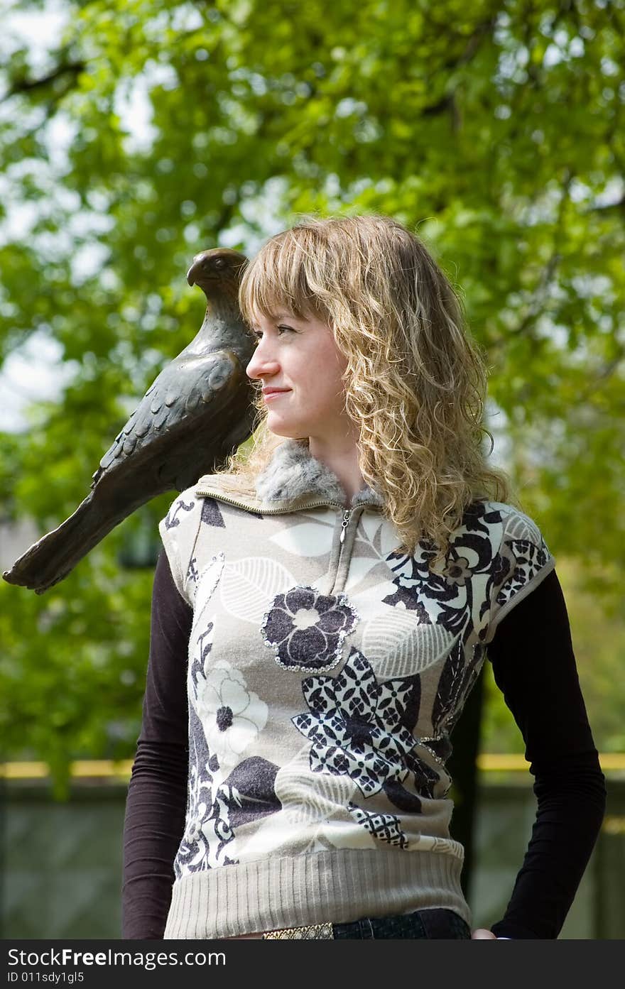 The girl with a stone eagle on a shoulder