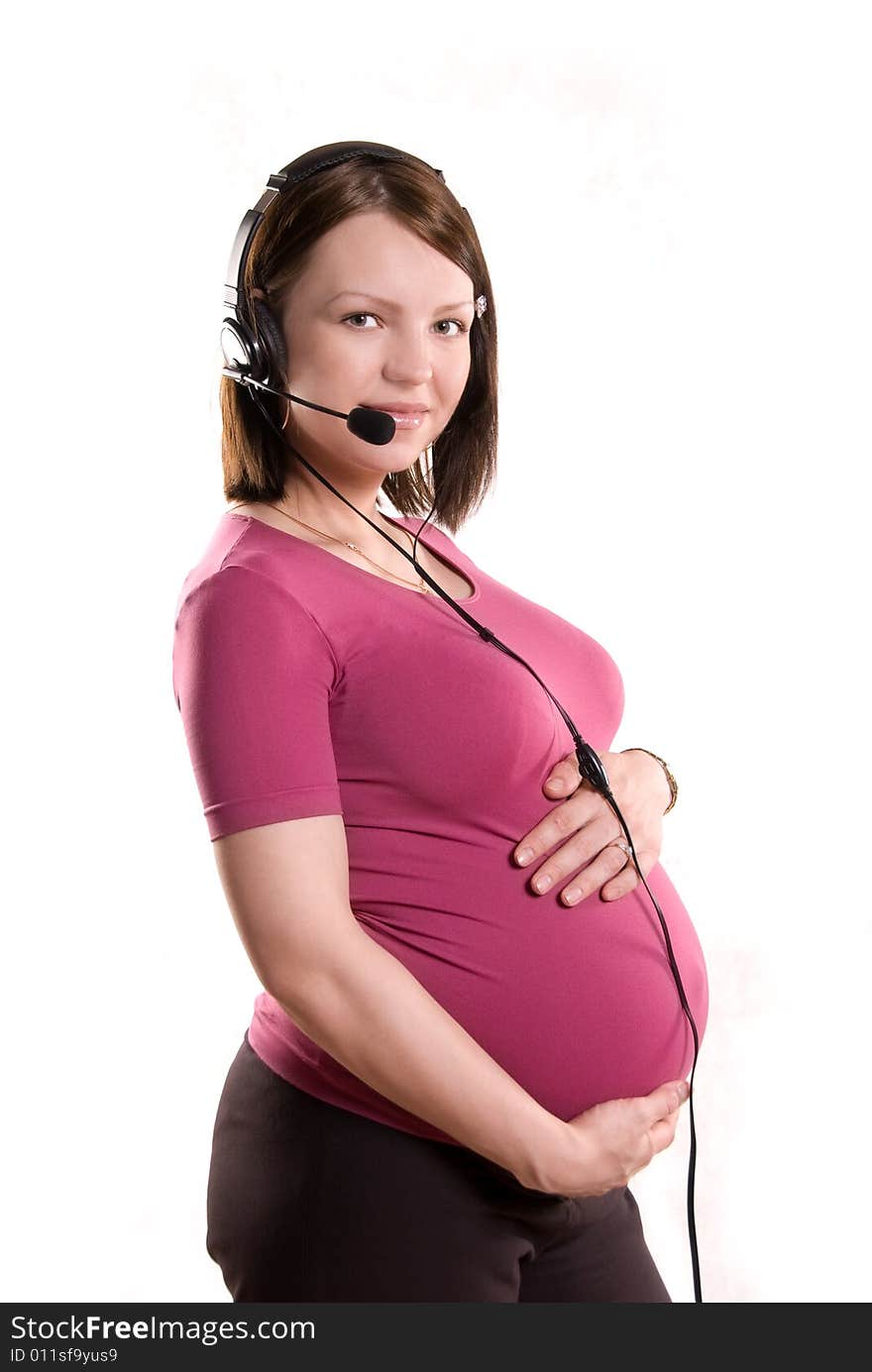 Pregnant woman wearing earphones with a microphone