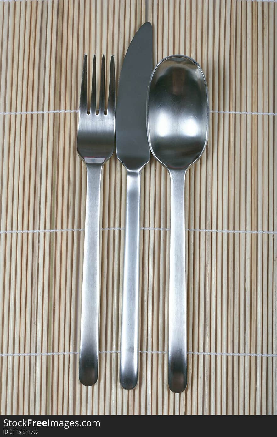 Fork knife and spoon on bamboo