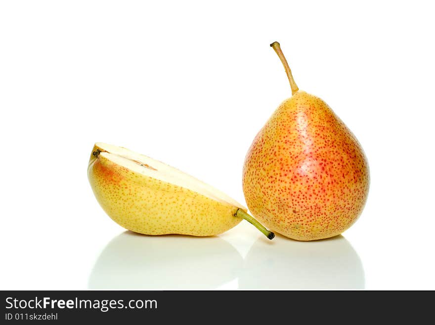 Whole yellow-red pear and half isolated on the white background