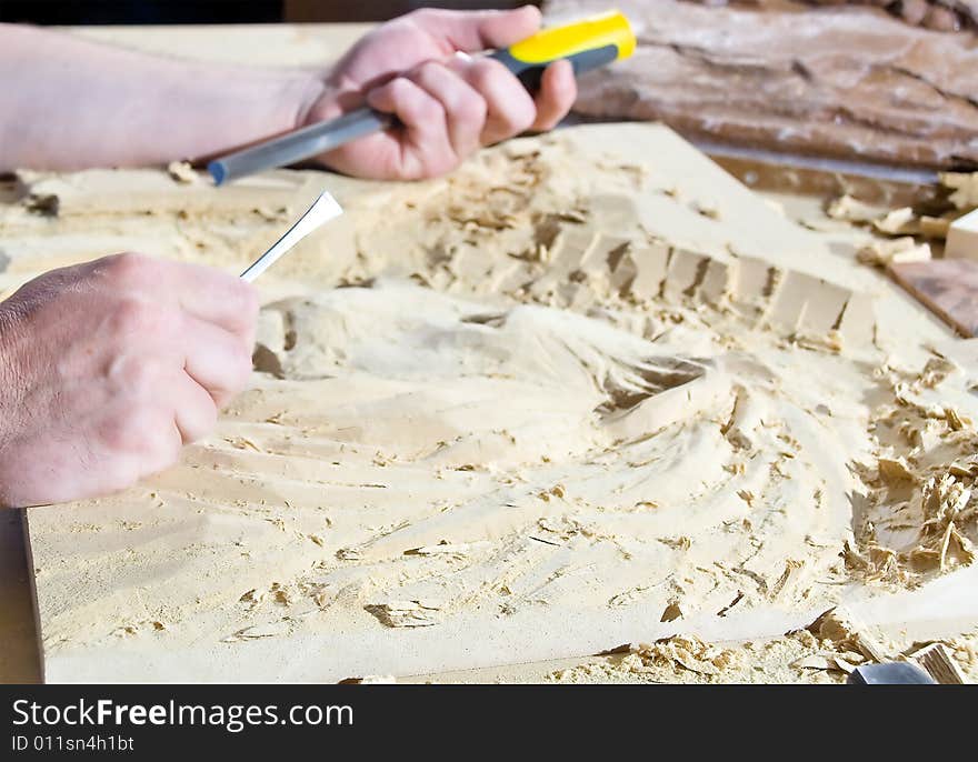 Hands of the carver.work place. Hands of the carver.work place