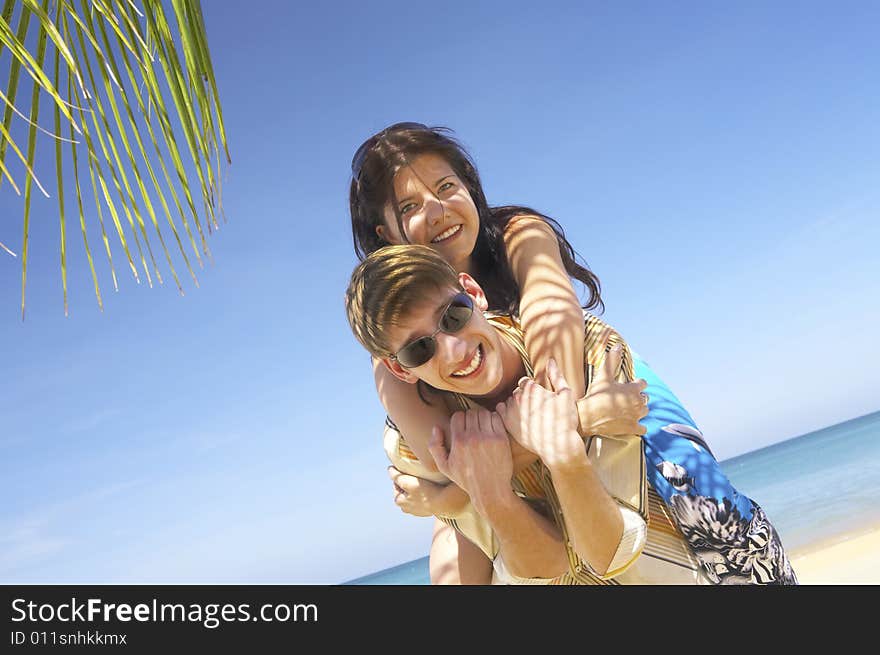 A portrait of attractive couple having date on the beach. A portrait of attractive couple having date on the beach