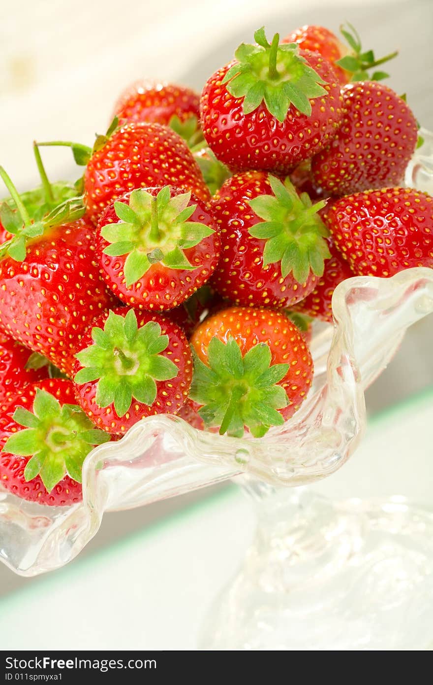 High key photo of fruit dish filled with nice red strawberries. High key photo of fruit dish filled with nice red strawberries