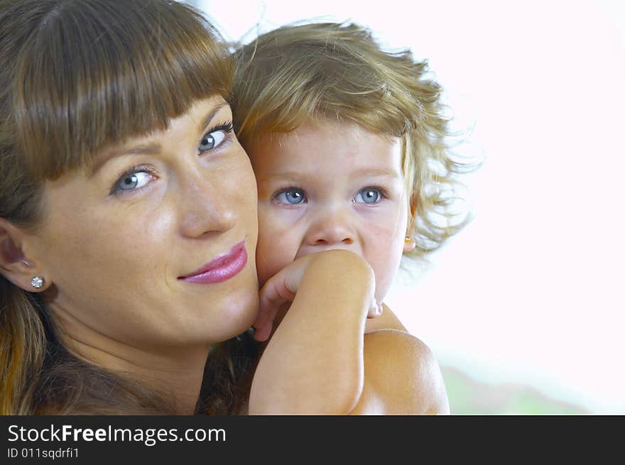 High key portrait of happy mother with baby. High key portrait of happy mother with baby