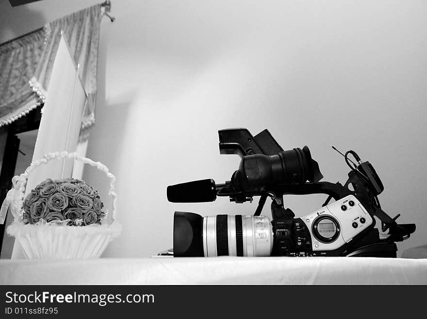 A professional camera and a bouquet of flowers