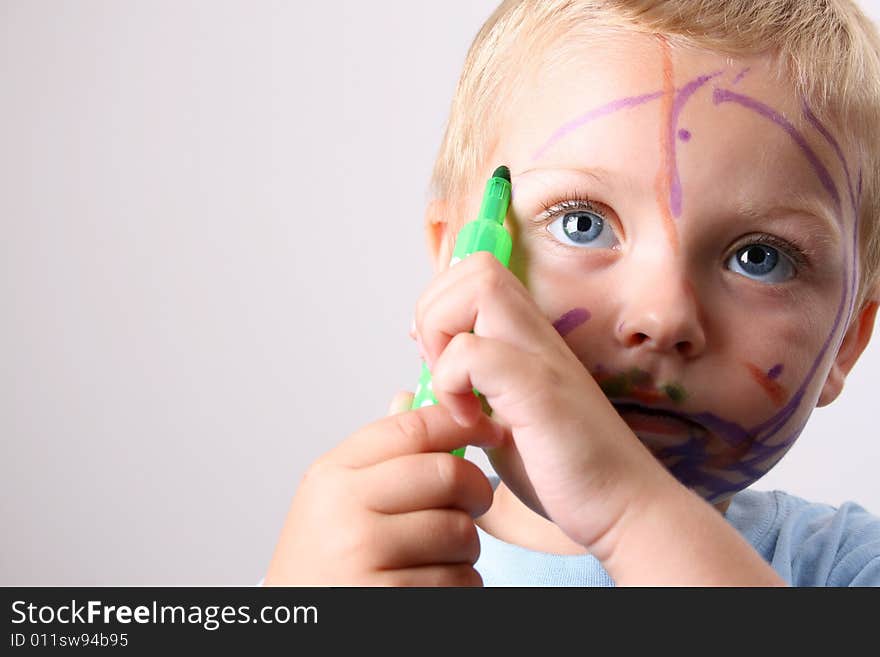 Laughing Toddler playing with colored pens making a mess. Laughing Toddler playing with colored pens making a mess