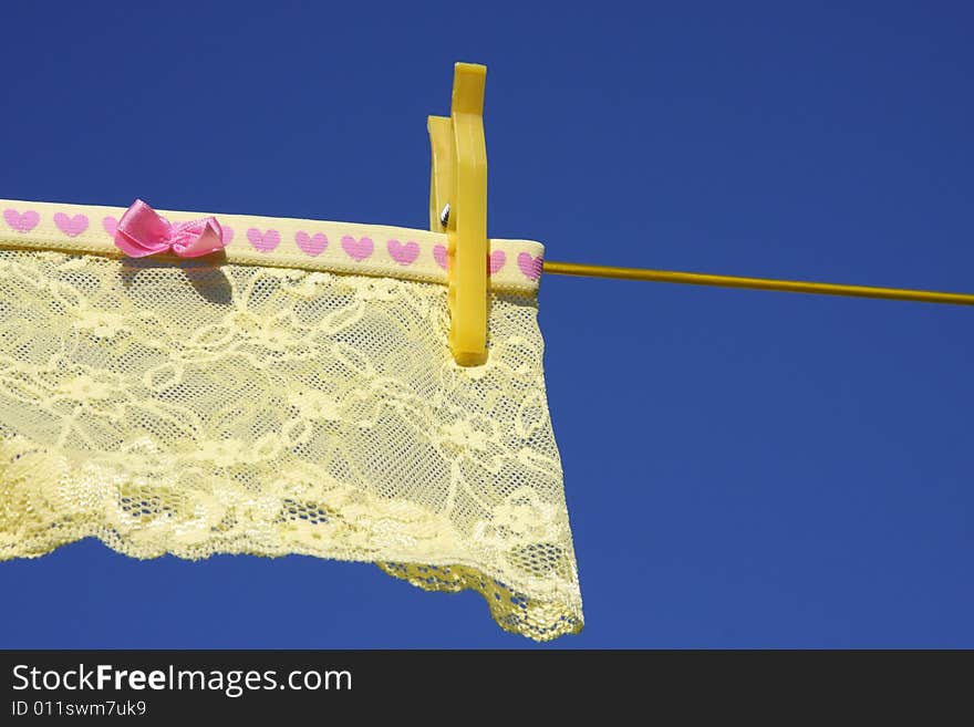 Yellow Clothes, lingerie on washing laundry line blue skies. Yellow Clothes, lingerie on washing laundry line blue skies