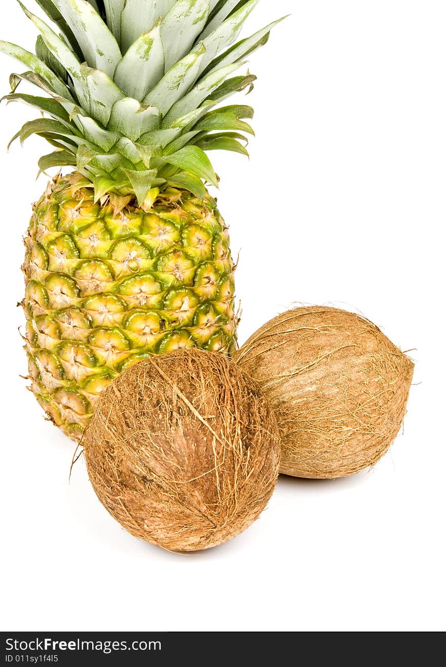 Pineapple and coconuts isolated on white. Pineapple and coconuts isolated on white.