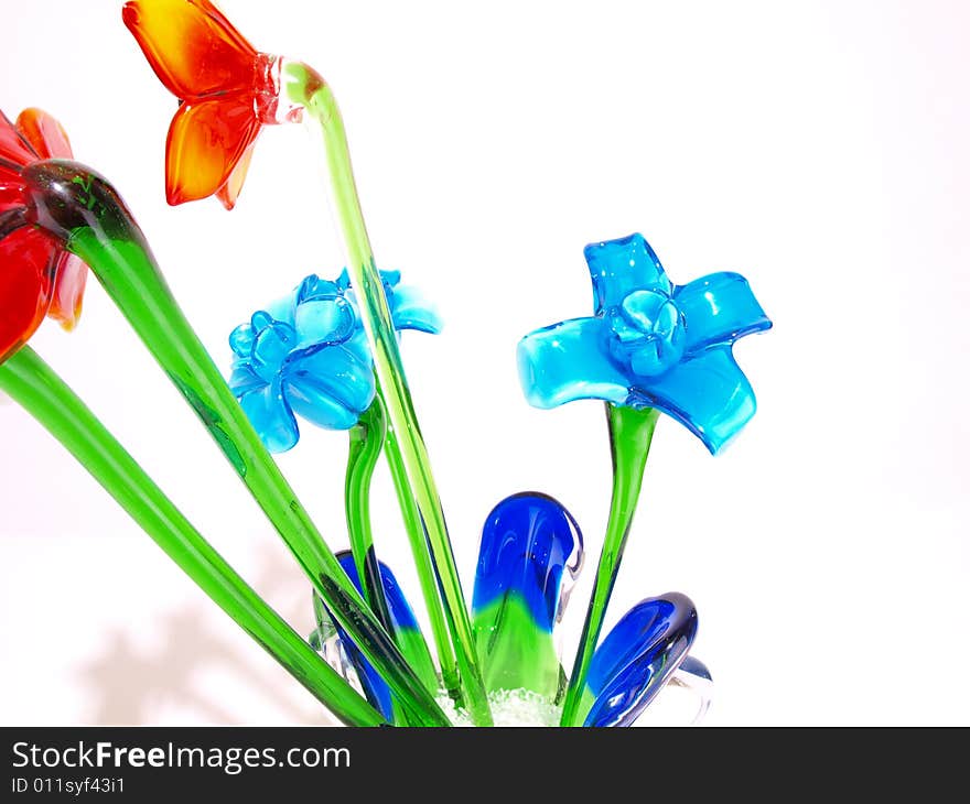 Shiny Blue crystal flowers with green stems among others