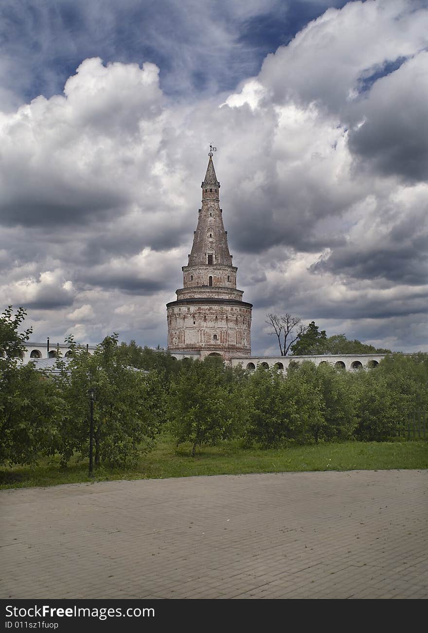 Aancient tower and walls on cloudy sky. Aancient tower and walls on cloudy sky