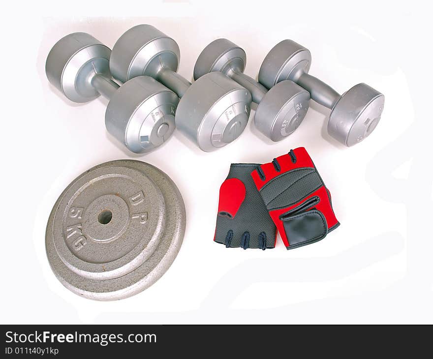 Various types of weights & a pair of red gloves. Various types of weights & a pair of red gloves