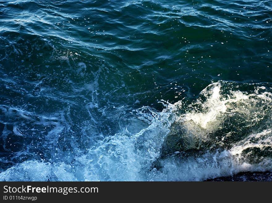 An image of a wave in blue sea