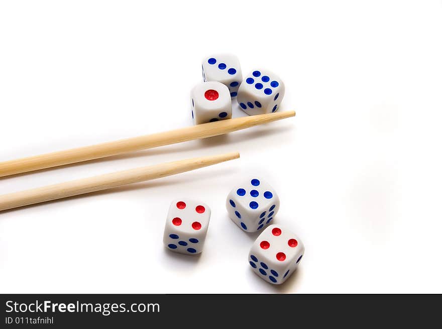 Chopsticks and dices on white background