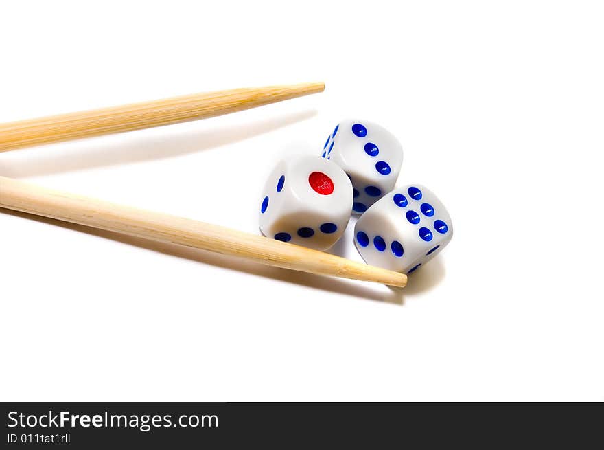 Chopsticks and dices on white background