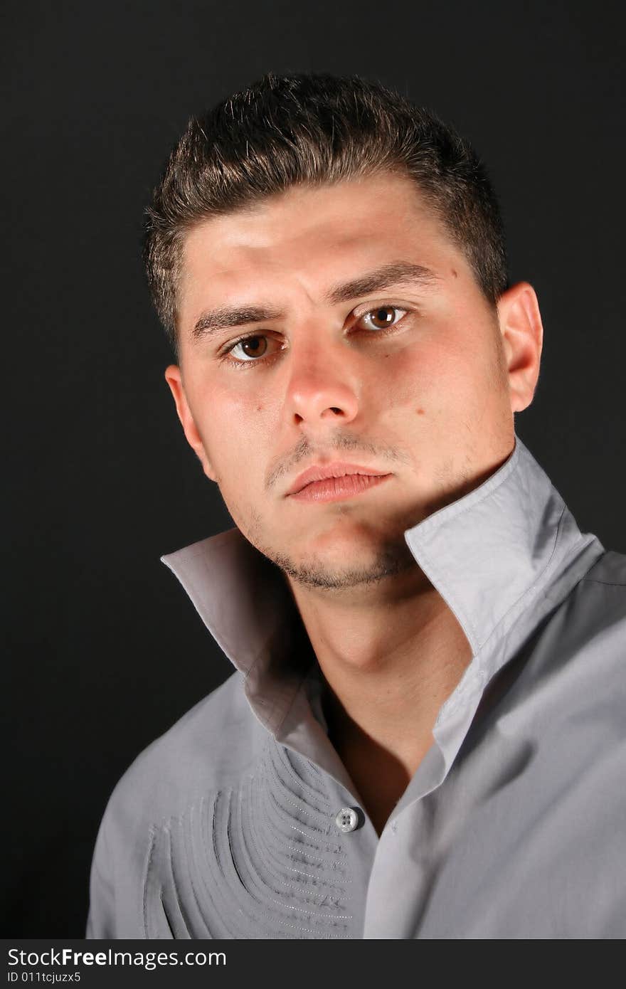 Male model in studio against black background