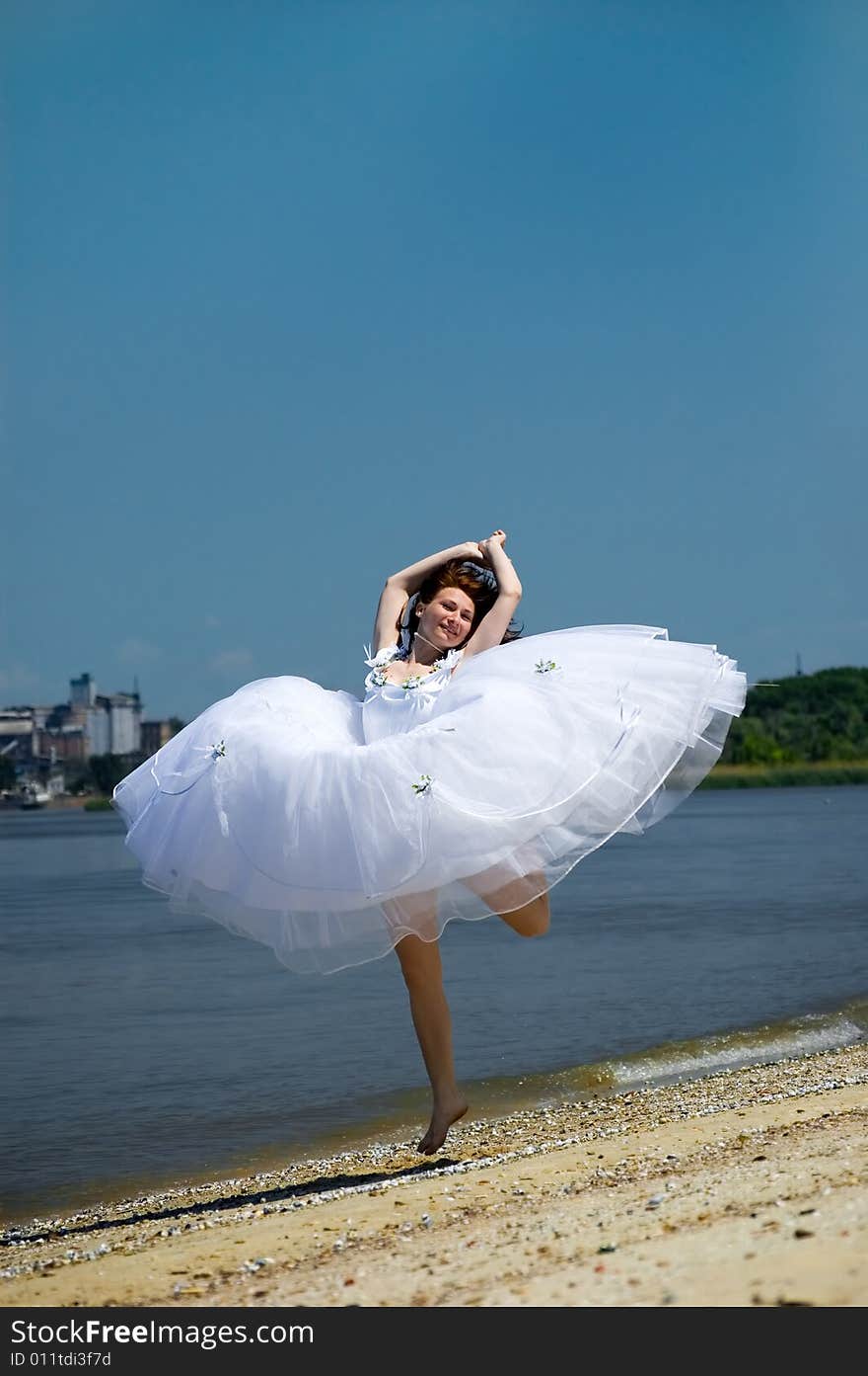 Bride jumping on a sandy beach. Bride jumping on a sandy beach