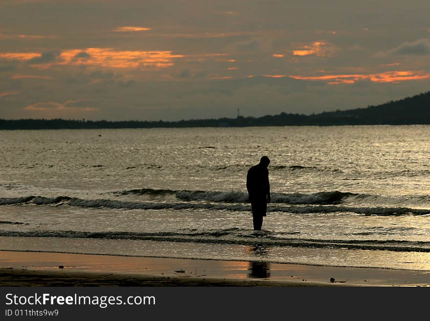 Wading against a sunset on the beach. Wading against a sunset on the beach