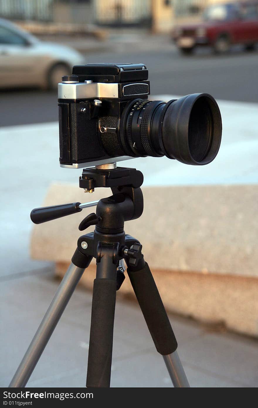 A black reflex camera on a support. A black reflex camera on a support