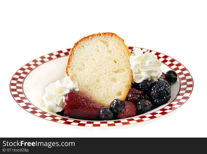 A piece of pound cake with mixed berries isolated on a white background. A piece of pound cake with mixed berries isolated on a white background.