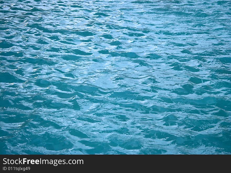 Pool blue water background in a windy day