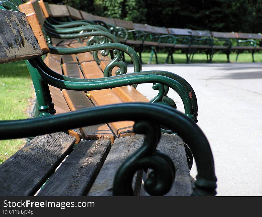 Bunch of empty benches in the park at sunny day. Bunch of empty benches in the park at sunny day