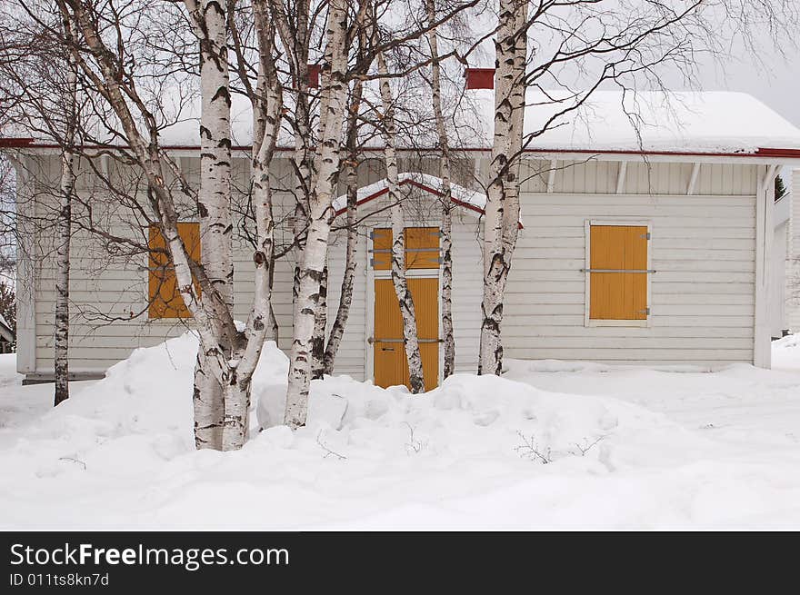 Snow covered wooden house