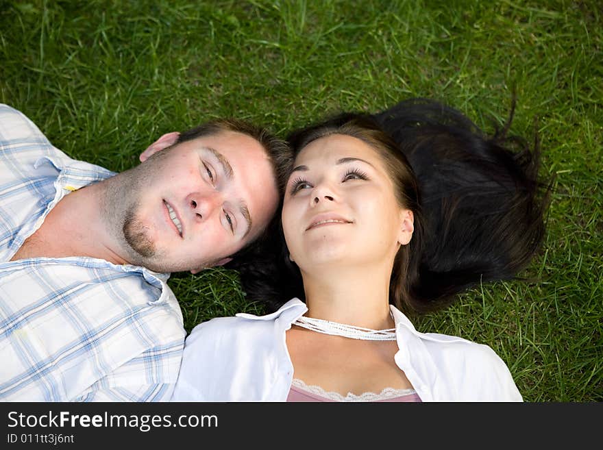 Happy couple relaxing on grass. Happy couple relaxing on grass