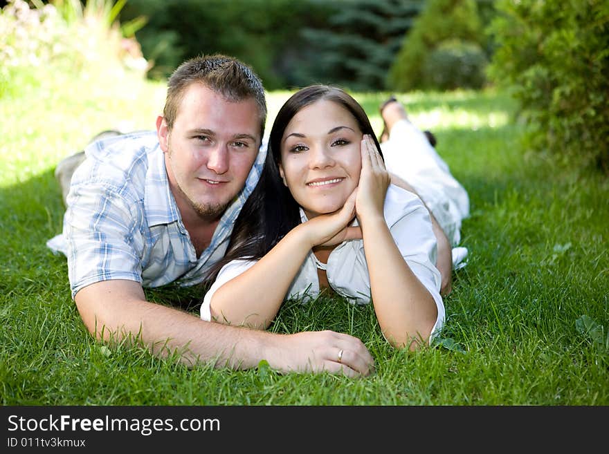 Happy couple relaxing on grass. Happy couple relaxing on grass