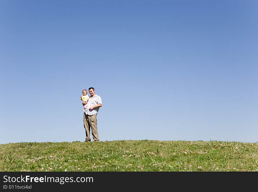 Happy family on green meadow. Happy family on green meadow