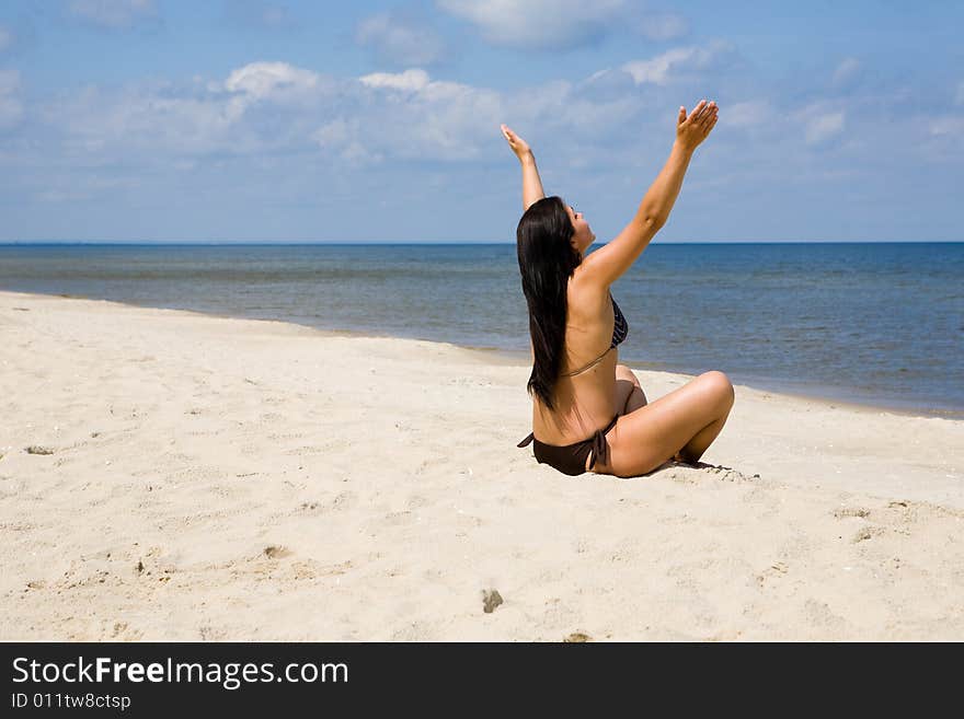 Attractive brunette woman relaxing on beach. Attractive brunette woman relaxing on beach